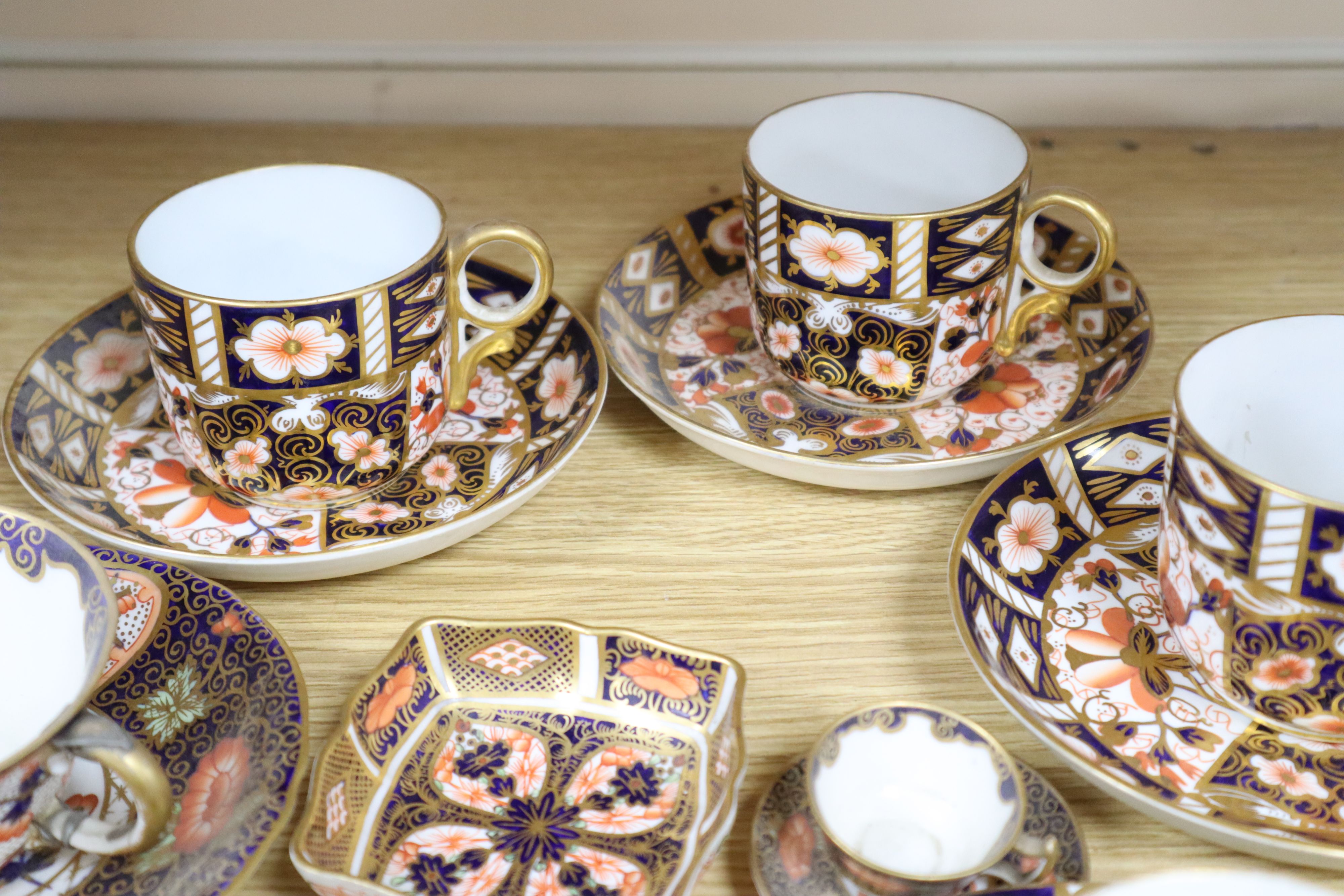 A collection of six Royal Crown Derby cups and saucers, a small square trinket dish and a miniature cup and saucer (16)